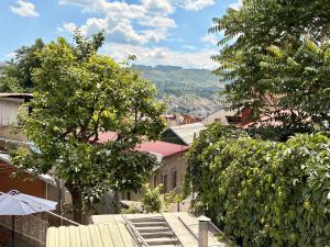 a street with trees and stairs in a city at SDD Brothers - Дом с балконом в сердце Тбилиси in Tbilisi City