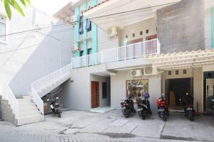 a group of motorcycles parked outside of a building at RedDoorz near UGM 3 in Yogyakarta
