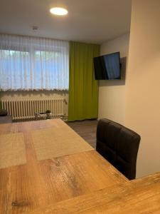 a conference room with a table and a flat screen tv at Dünenhaus Souterrain Strandallee 3 in Timmendorfer Strand
