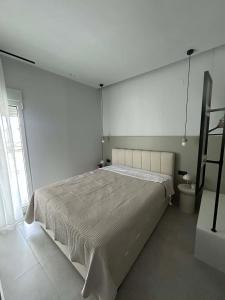 a bedroom with a large bed in a white room at Angelica Suites Keramoti Area in Keramoti +7 photos