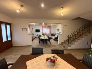 a dining room and living room with a table and chairs at Gold Fayen House Cheile Turului in Tureni