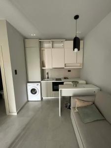 a kitchen with a couch and a table in a room at Angelica Suites Keramoti Area in Keramoti