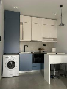 a kitchen with a washing machine and a washer at Angelica Suites Keramoti Area in Keramoti