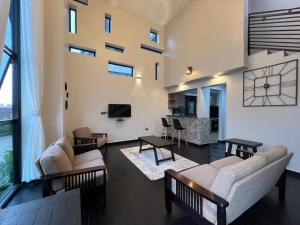 a living room with two couches and a table at DLK Living in Kampala