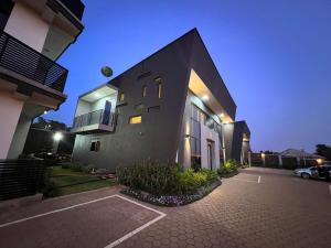 a house with a parking lot in front of it at DLK Living in Kampala