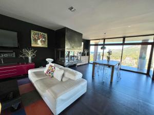 a living room with a white couch and a table at Villa Mare Monti in Lumio