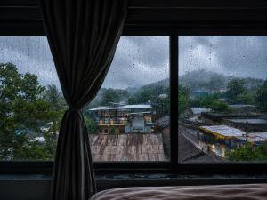 a bedroom window with a view of a train yard at Unity homestay in Garudeshwar