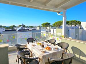 a table on a balcony with a table and chairs at Sunny Beach Penthouse 271 in Lalzit Bay
