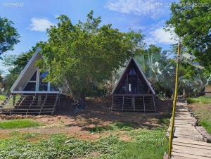 a small house with a triangular roof and stairs at 385 Homestay & Lake camp in Ban Khai Nao (1)