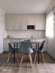 a kitchen with a table and chairs and a microwave at Domki u Piotrusia in Żarnowska