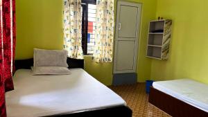 a small room with two beds and a window at Two in One Restaurant & Lodge in Pokhara