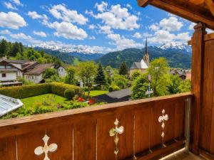 a balcony with a view of a town and mountains at Hotel Schatten in Garmisch-Partenkirchen