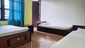 a room with two beds and a bath tub at Two in One Restaurant & Lodge in Pokhara