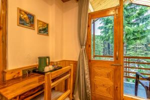 a room with a wooden desk and a window at Getaway Stays Manali in Manāli