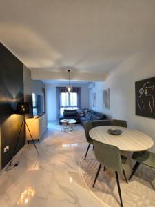 a living room with a table and a couch at Eclipse Luxury Suite in Šušanj