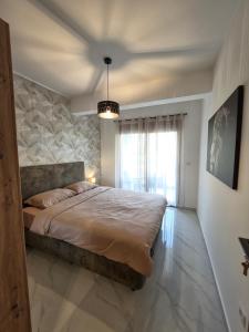 a bedroom with a large bed and a window at Eclipse Luxury Suite in Šušanj