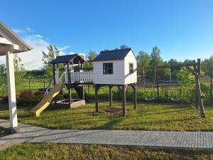 a playground with a play house and a slide at Domek Za Wyspą 1 in Chmielów +8 photos