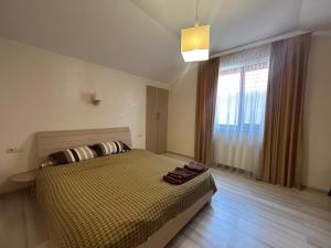 a bedroom with a bed and a large window at Villa Life Family Sea House in Zatoka