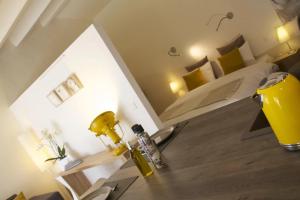 a bedroom with a table and a bed with a yellow lamp at Alegria Studios - en Provence - Piscine avec vue - Terrasse privative in Aups