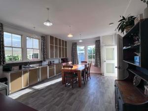 a kitchen and dining room with a table and chairs at Destination Cliff Top - Cottage and Homestead in Ohingaiti