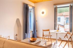 a living room with a couch and a table at Gaia Trikeri Suites in Ayía Kiriakí