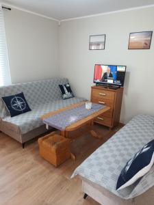 a living room with a couch and a table at Manta Apartamenty in Sianozety