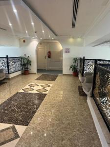 a lobby with a waiting room with chairs and plants at شقق برج نوران للشقق المخدومة Nouran Tower Serviced Apartments in Al Khobar