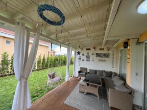 a screened porch with a couch and a table at Casa 18 in Sveti Vlas