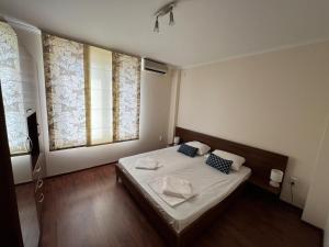 a bedroom with a large bed with white sheets and blue pillows at Casa 18 in Sveti Vlas
