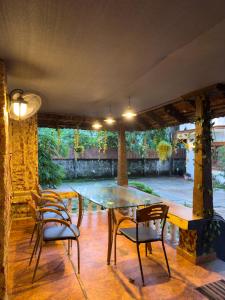 a patio with a glass table and chairs at Samudra heritage in Cochin