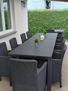 a black table and chairs with plants on it at Manta Apartamenty in Sianozety