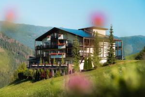 a building on top of a hill in the mountains at Bellavista Emma in San Vigilio Di Marebbe