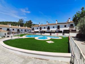 a courtyard with two swimming pools in a building at Carpe Diem Bosque in El Bosque