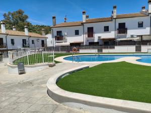a courtyard with a swimming pool in front of a building at Carpe Diem Bosque in El Bosque