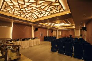 a large room with chairs and a stage in it at raj Regent kurichy in Putuppalli