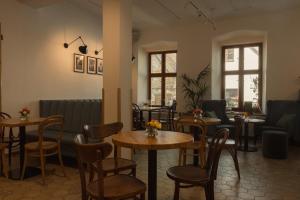 a restaurant with tables and chairs in a room at Vlaštovčí dům in Nové Město nad Metují