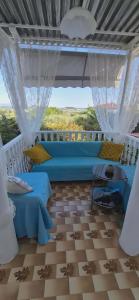 a living room with a blue couch and a table at Olive Garden Estate in Elevtheraí