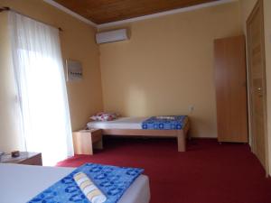 a small room with a bed and a window at Guesthouse Feel Lake in Virpazar