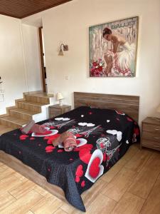 a bedroom with a large bed with a woman on it at Love Holiday Suite 1 in Tris Elies