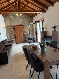 a living room with a wooden table and a couch at Love Holiday Suite 1 in Tris Elies