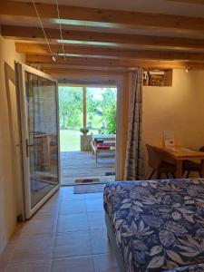 a bedroom with a bed and a sliding glass door at Estefana in Chambilly