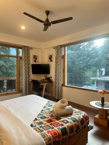 a bedroom with a bed and a large window at Getaway Stays Manali in Manāli