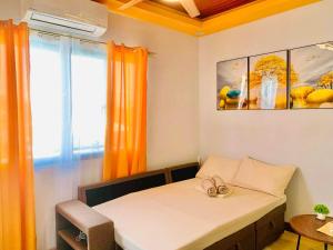 a bedroom with a bed with an orange curtain at Endless Summer Seafront - 1BR Beach Resort Condo in San Juan +40 photos