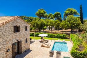 an external view of a house with a swimming pool at Villa Boscheto Pente in Agios Leon