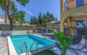 a swimming pool in the backyard of a house at Lotus Villas Resort in Pula