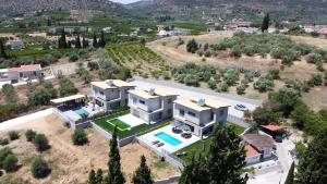 an aerial view of a large white house at Elysian View Lefkakia in Nafplio