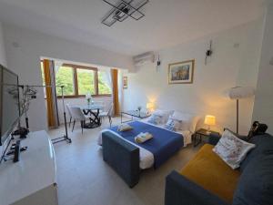 a living room with a bed and a couch at Luxury Villa Ivona Pool, Jacuzzi, Sauna & Privacy in Ošlje +35 photos