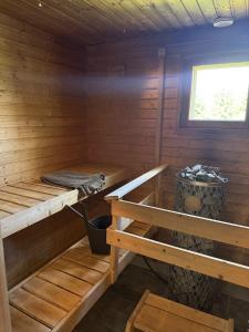 a cabin with two bunk beds and a window at Treeline Cottage in Rovaniemi