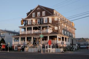a large building on the corner of a street at Hotel Macomber ADULTS ONLY in Cape May