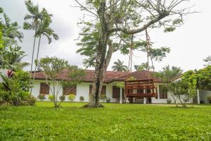 a house with a tree in front of it at Lullaby Marine Villa in Wadduwa